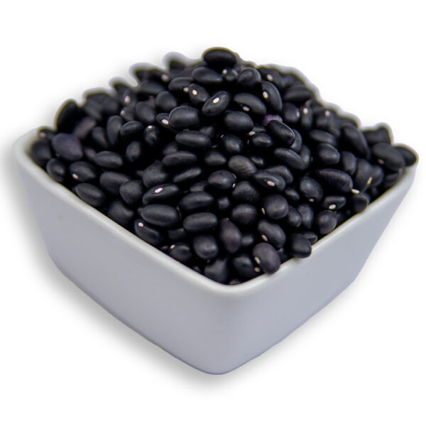 A white bowl filled with dry black beans, showcasing their smooth texture and deep black color.