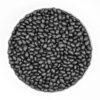 A white bowl filled with dry black beans, showcasing their smooth texture and deep black color.