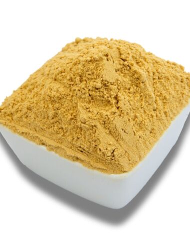 A white bowl filled with ground ginger, showcasing its fine texture and warm, golden-brown color.