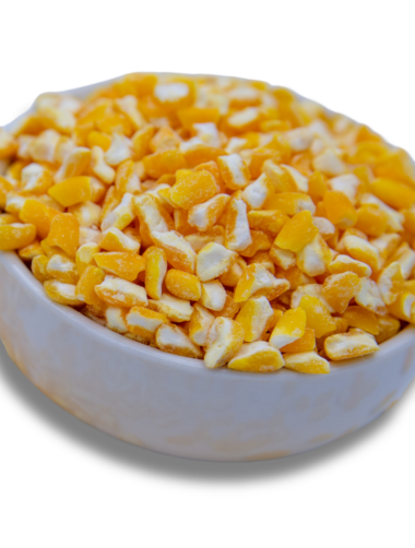 A white bowl filled with golden hominy corn, showcasing its unique texture and bright golden color.
