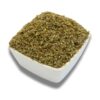 A white bowl filled with dried marjoram, showcasing its delicate leaves and muted green color.