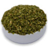 A white bowl filled with dried parsley, showcasing its vibrant green color and fine texture.