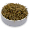 A white bowl filled with dried rosemary leaves, showcasing their vibrant green color and fragrant aroma.