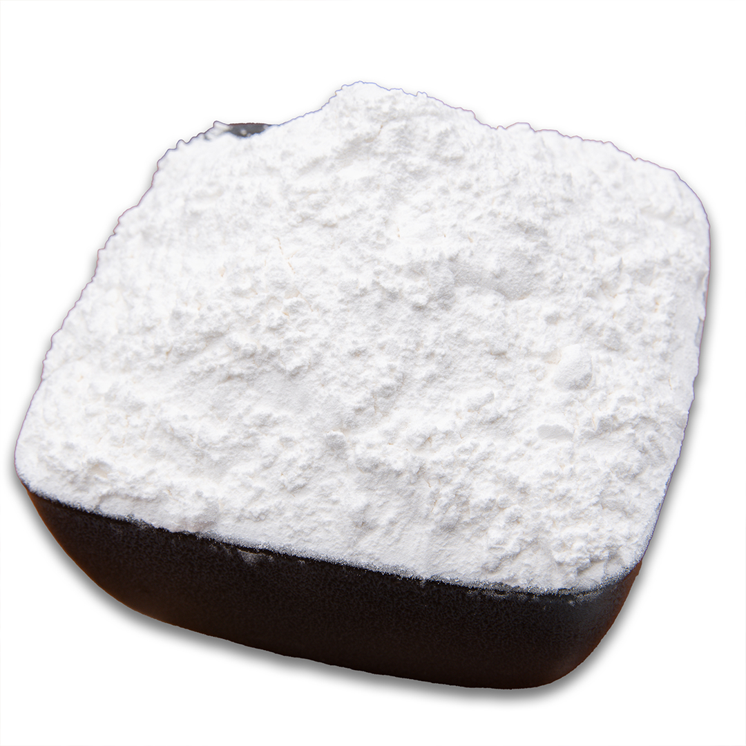 A white bowl holds a mound of corn starch, its pure white color and fine, powdery texture evident.