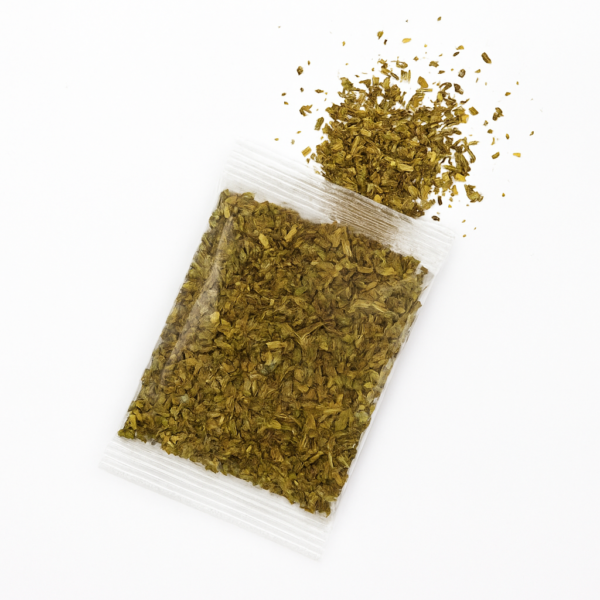 A white bowl filled with vibrant Italian seasoning, showcasing its colorful blend of herbs and spices.