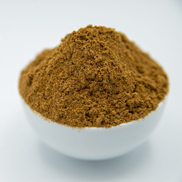 A white bowl filled with ground cumin, showcasing its fine texture and warm brown color.