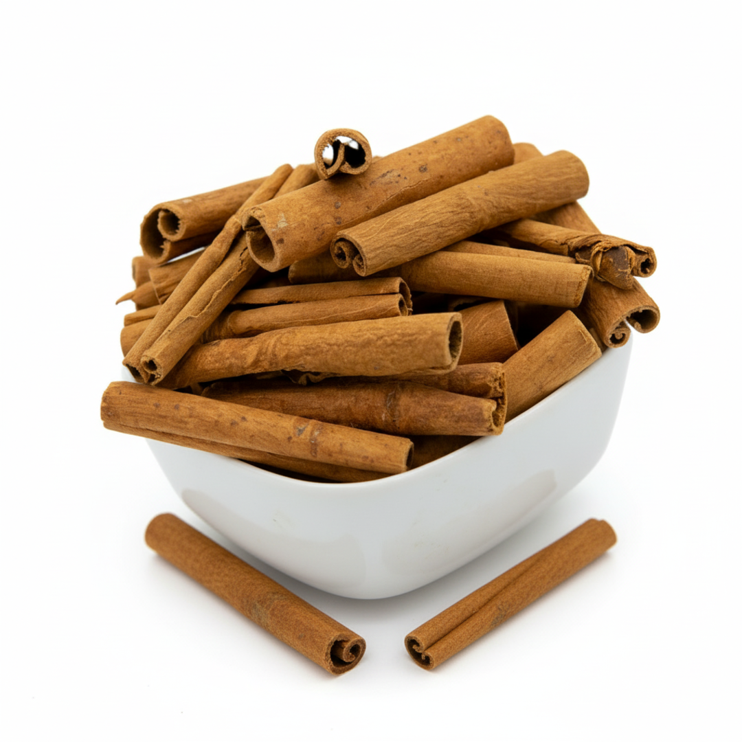 A white bowl filled with cinnamon sticks, showcasing their rich brown color and textured bark.